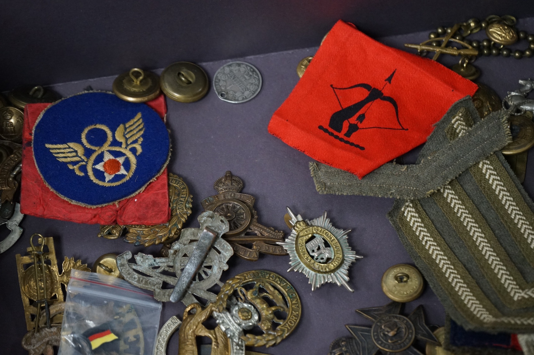 A collection of military medals and cap badges, etc. including